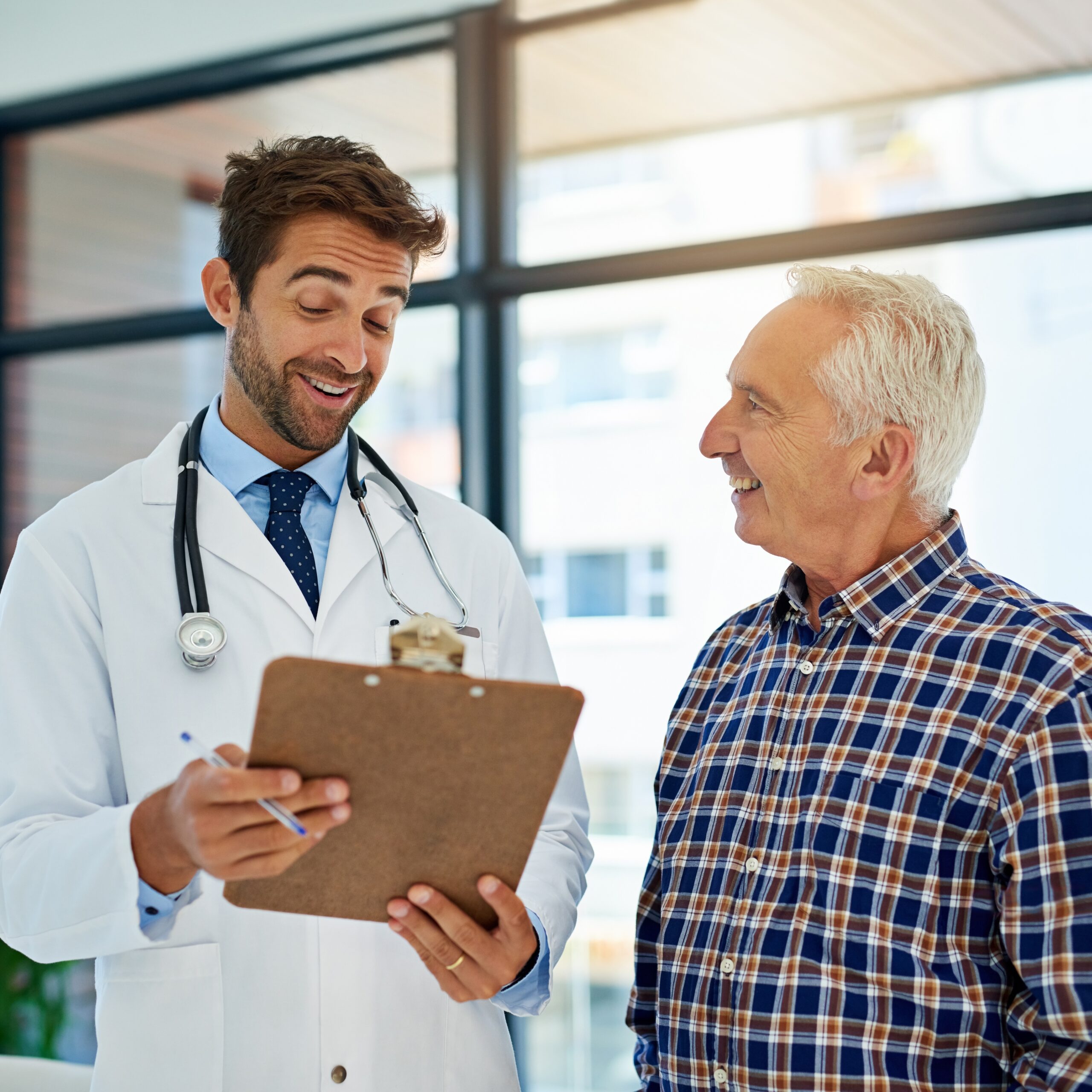 Young male doctor with older patient